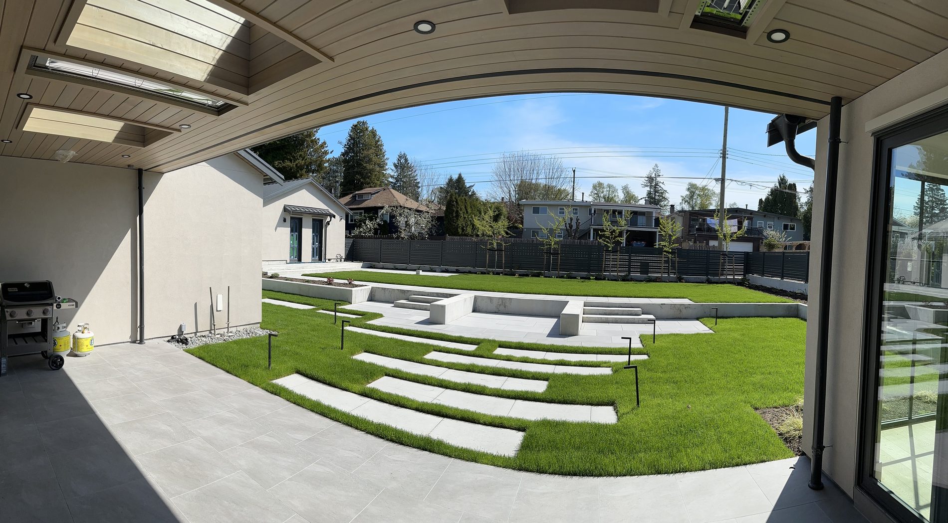 Covered outdoor room and terraced backyard