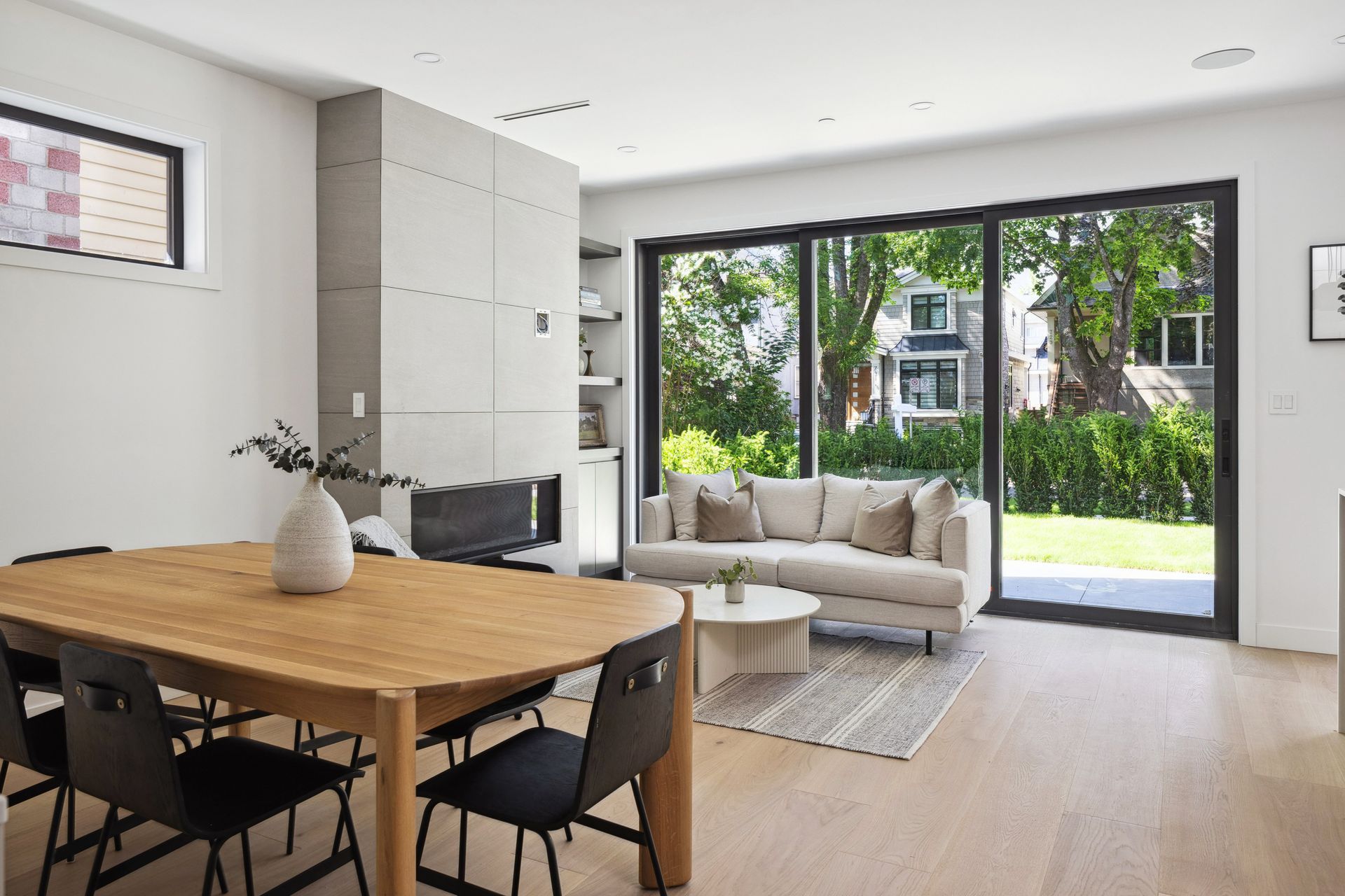 Living and dining area with fireplace and sliding doors to the yard