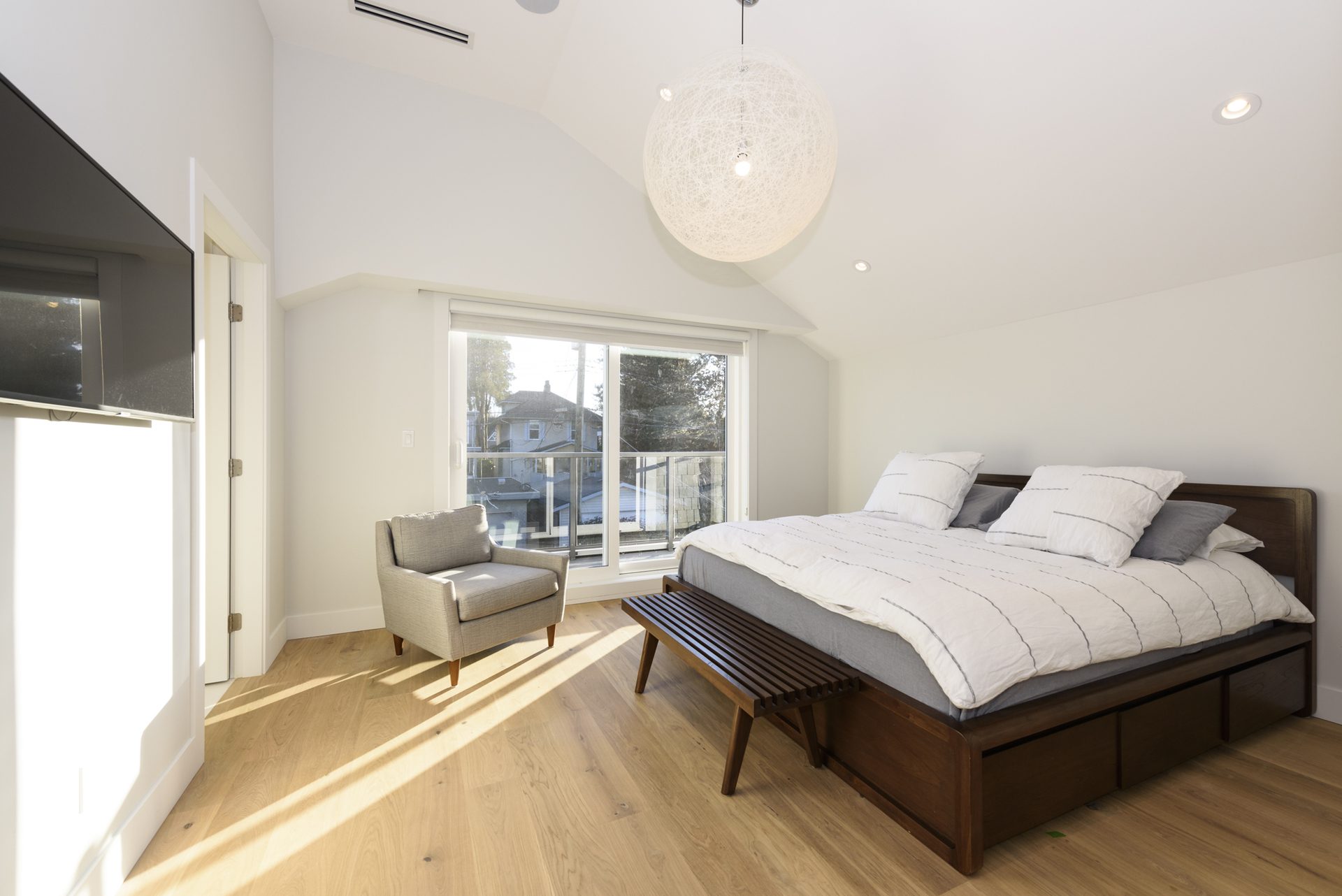 Primary bedroom with vaulted ceiling